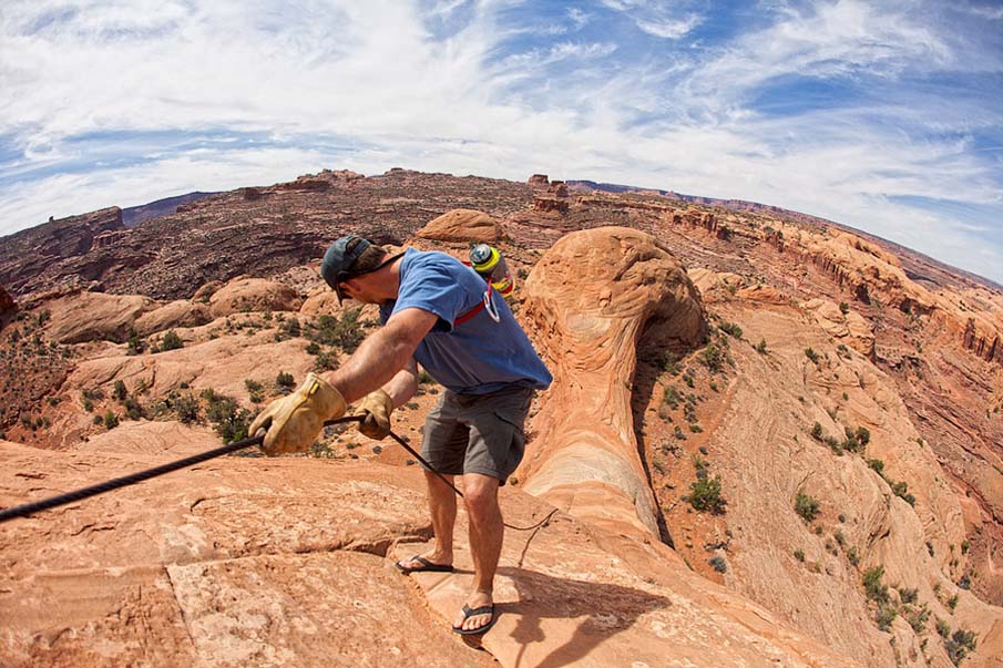 Hiker Descending Cable on Slickrock, Utah