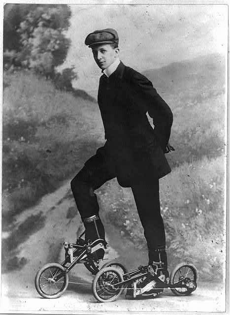 Young man on roller skates that are pedaled. Nov. 8, 1910.