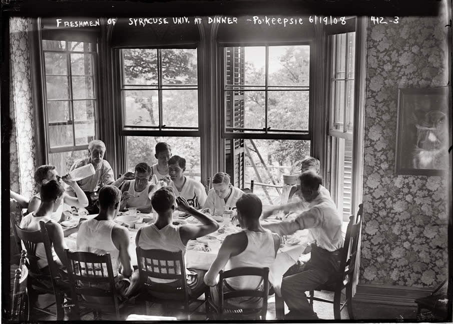 Syracuse freshmen on the rowing team sit around the dinner table on June 19, 1908.