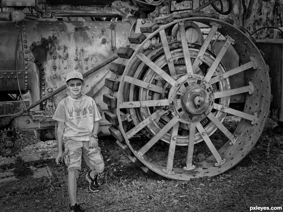 Boy by steam tractor