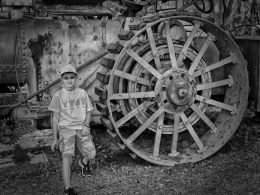 Boy by steam tractor