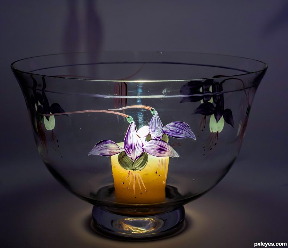 Glass bowl lit by candle