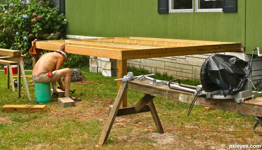 Southern carpenter in uniform building a patio
