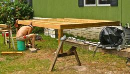 Southern carpenter in uniform building a patio