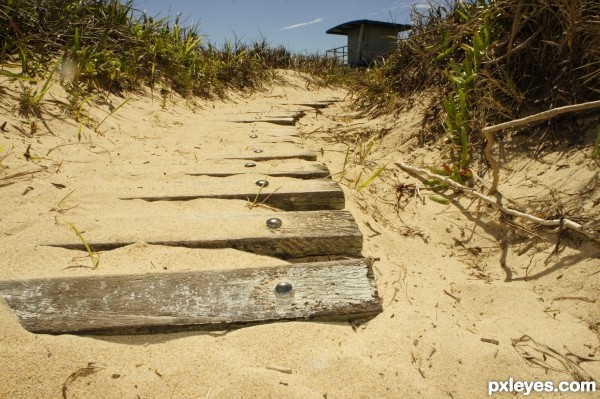 Red rock path to beach