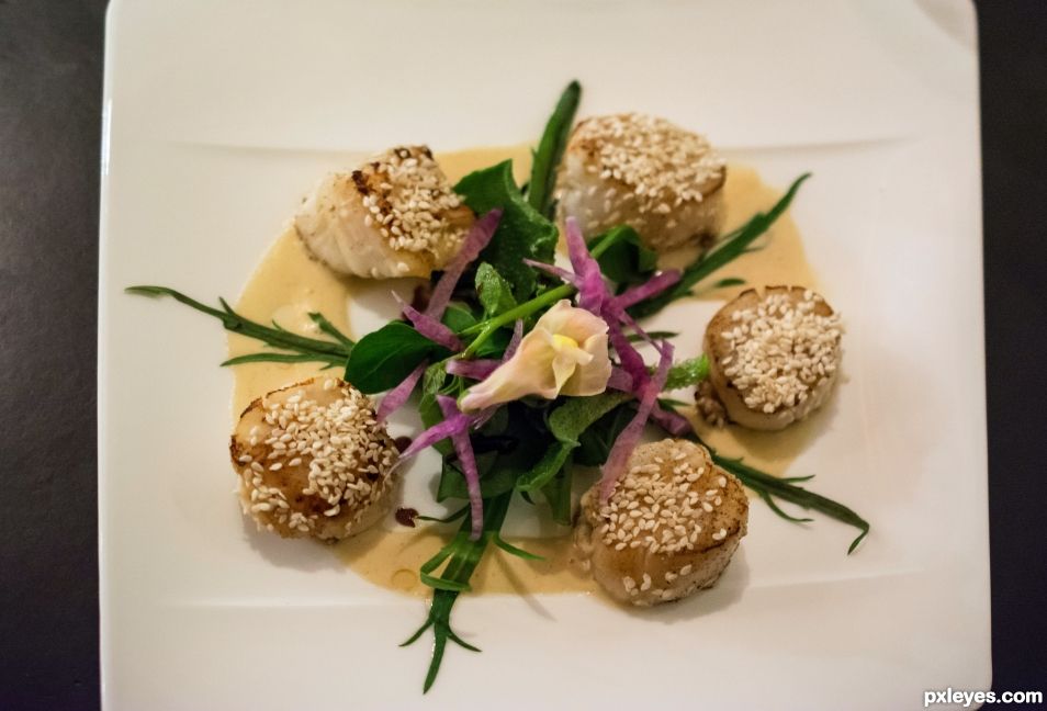 Pan-fried scallops topped with sesame seeds
