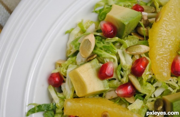 Raw Brussel Sprout, Avocado, Orange, and Pepitas Salad Close-up