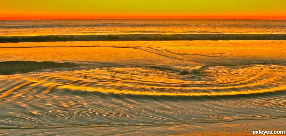 Tide coming in across the sandbar at sunrise