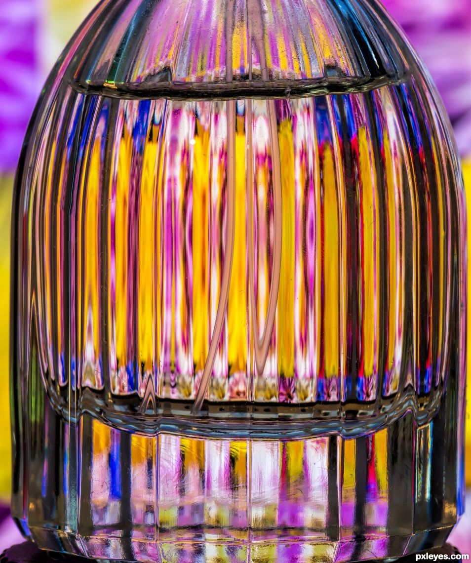 colours behind a perfume bottle.