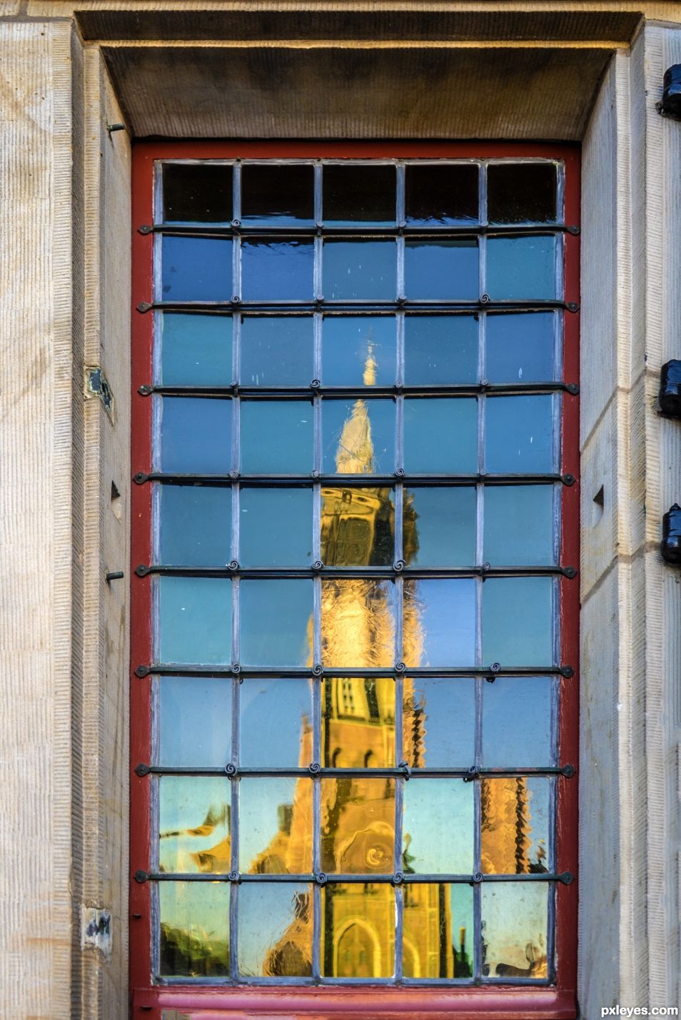 The old window across the church has lumps