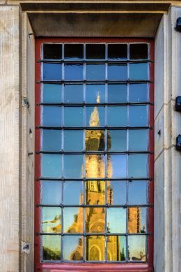 The old window across the church has lumps