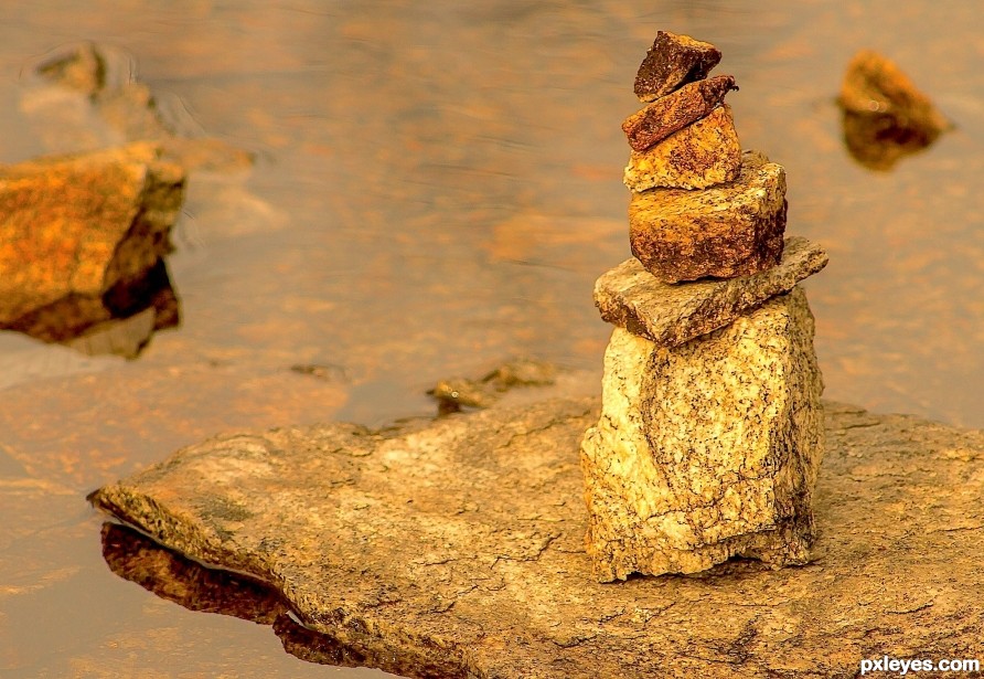 Small rocks stacked in a small stream  