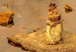 Small rocks stacked in a small stream  