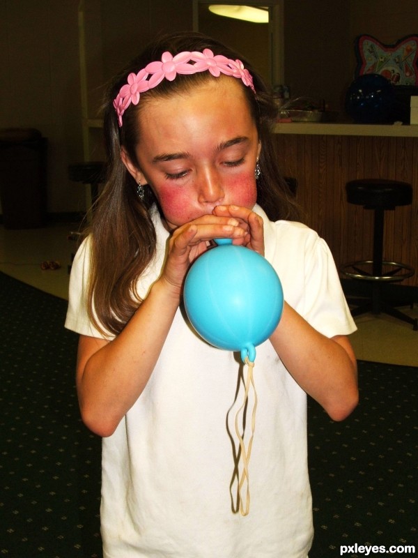 struggling to blow up balloon