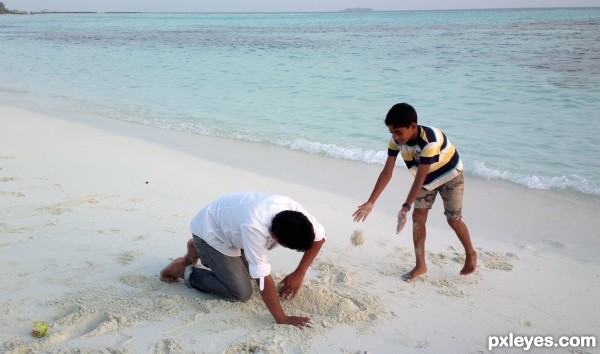 Cousins playing with sand