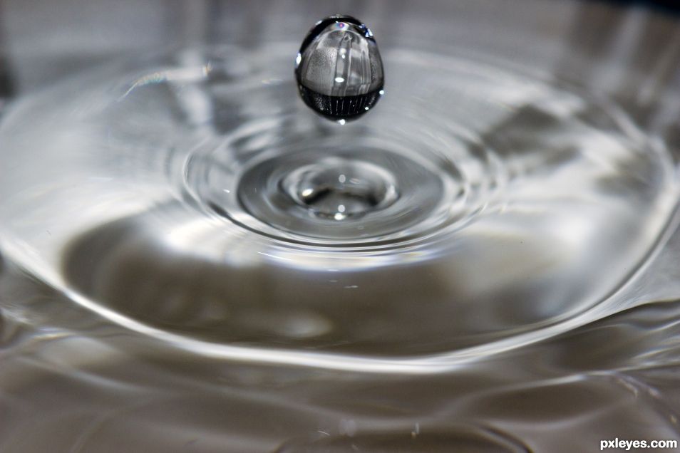 Water drop from chemical beret in bucket of water