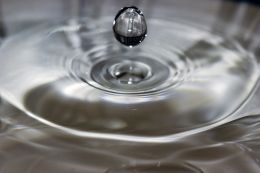 Water drop from chemical beret in bucket of water